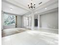 Bright living room featuring elegant chandelier and large windows offering lots of natural light at 1213 Brampton Pl, Lake Mary, FL 32746