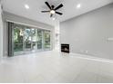 Spacious living room featuring a fireplace, sliding glass doors, and neutral color palette at 1213 Brampton Pl, Lake Mary, FL 32746