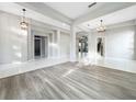 Bright and airy living room with neutral paint, tile and wood floors, and modern lighting at 1213 Brampton Pl, Lake Mary, FL 32746