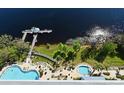 Stunning aerial view of community pool, dock, and lake creating a resort-like atmosphere at 13427 Blue Heron Beach Dr # 1802, Orlando, FL 32821