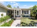 Cozy front porch with white columns and a seating area at 1564 Cavendish Rd, Winter Park, FL 32789