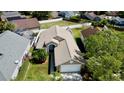 Aerial view of a tan single Gathering home featuring a well-maintained lawn and surrounded by neighboring houses at 193 Lansbrook Ct, Ocoee, FL 34761