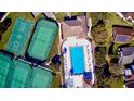 Overhead shot of community pool, tennis and basketball courts with lounge chairs ready for relaxation at 193 Lansbrook Ct, Ocoee, FL 34761
