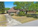 Ranch home with a spacious driveway and well-maintained landscaping and mature shade tree at 20705 Nettleton St, Orlando, FL 32833