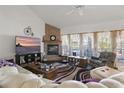 Cozy living room with a brick fireplace, neutral-toned furniture, and ample natural light at 20705 Nettleton St, Orlando, FL 32833