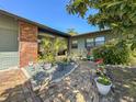 Inviting brick-paved courtyard with vibrant potted plants, creating a charming and colorful entryway at 2601 Windward Ct, Orlando, FL 32805