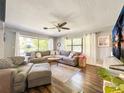 Bright living room features a large sectional sofa, wood floors, and lots of natural light at 2601 Windward Ct, Orlando, FL 32805