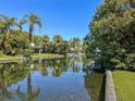 Scenic view of the tranquil canal, enhanced by lush greenery and swaying palm trees at 2601 Windward Ct, Orlando, FL 32805