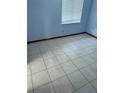Cozy bedroom with a large window, tiled floors and neutral walls, offering a simple and comfortable space at 2618 Adela Ave, Orlando, FL 32826