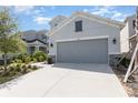 Charming home with a two-car garage, gray paint, stone accents, and well-maintained landscaping at 2865 High Pointe St, Clermont, FL 34711