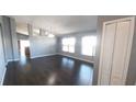 Bright living room featuring wood flooring, gray walls, and an open layout with ample natural light at 3131 Effingham Dr, Clermont, FL 34714