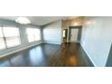 Spacious living area with wood flooring, vaulted ceilings, and neutral paint, providing a blank canvas at 3131 Effingham Dr, Clermont, FL 34714