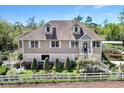 Charming home exterior with manicured landscaping, white picket fence, and a covered porch at 3149 Scrub Oak Trl, Oviedo, FL 32765