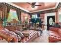 Cozy living room with luxurious leather seating, decorative ceilings, and large windows at 3149 Scrub Oak Trl, Oviedo, FL 32765