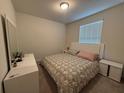 Cozy bedroom with a comfortable bed, white furniture, and natural light from the window at 3990 Lana Ave, Davenport, FL 33897
