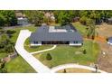 Aerial view of an updated ranch home featuring a long driveway, pool, and large backyard at 400 Royal Palm Ct, Longwood, FL 32779