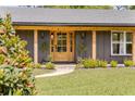 Close up of the attractive front door and well maintained landscaping at 400 Royal Palm Ct, Longwood, FL 32779