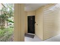 Close-up of the unit's front door, showcasing its private entrance and welcoming ambiance at 404 Summit Ridge Pl # 110, Longwood, FL 32779
