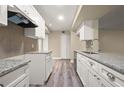 Bright kitchen with granite countertops, white cabinets, and stainless steel appliances at 404 Summit Ridge Pl # 110, Longwood, FL 32779