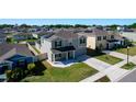 A peaceful neighborhood featuring cozy homes with well-maintained lawns and tree-lined streets under a clear blue sky at 744 Simone Ct, Haines City, FL 33844