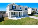 Beautifully landscaped front yard of this two-story home with an attached garage and inviting covered porch at 744 Simone Ct, Haines City, FL 33844