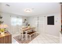 Bright dining room features a wooden table with bench seating, paired with white tile flooring at 7714 Lady Frances Way, Orlando, FL 32807