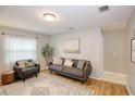 Cozy living room featuring a neutral color palette, hardwood floors, and stylish furniture arrangement at 7714 Lady Frances Way, Orlando, FL 32807