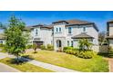 Attractive home with a landscaped lawn, stone accents, and a paver driveway, creating curb appeal at 8384 Ludington Cir, Orlando, FL 32836