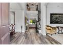 Elegant foyer with hardwood floors, a chandelier, and staircase leading to the second level at 8384 Ludington Cir, Orlando, FL 32836