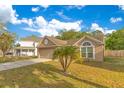 Lovely single-story house with a beautiful front yard and attached two-car garage at 1002 Kelsey Ave, Oviedo, FL 32765
