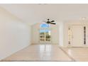 Spacious living room with neutral walls, decorative tile, and a large arched window offering natural light at 1002 Kelsey Ave, Oviedo, FL 32765