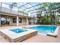 Screened-in pool with a hot tub is perfect for entertaining in this Florida home at 10176 Hart Branch Cir, Orlando, FL 32832