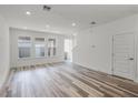 Spacious living room boasting hardwood floors, recessed lighting, and a modern, neutral color palette at 13532 Autumn Harvest Ave, Winter Garden, FL 34787