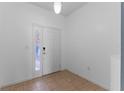 Bright foyer with tile flooring and a door with a side window at 13832 Dove Wing Ct, Orlando, FL 32828