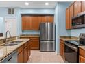 Modern kitchen with stainless steel appliances and granite countertops at 13832 Dove Wing Ct, Orlando, FL 32828