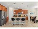 Well-equipped kitchen with stainless steel appliances, a central island, and counter seating, blending style and functionality at 1395 Olympic Club Blvd, Champions Gate, FL 33896