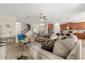 Spacious living room seamlessly connects to the kitchen, creating an inviting open-concept layout perfect for gatherings at 1395 Olympic Club Blvd, Champions Gate, FL 33896