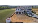New construction home overlooking the golf course has a large lot with an attached two car garage at 16048 Trivoli Cir, Bella Collina, FL 34756