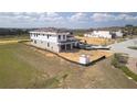 Home under construction with a golf course view has a large yard and an attached two car garage at 16048 Trivoli Cir, Bella Collina, FL 34756