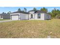 Exterior view showing the home's modern design, tidy landscaping, and inviting curb appeal at 16745 Sw 29Th Terrace, Ocala, FL 34473