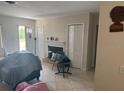 View of the living room with tile flooring and a decorative fireplace at 2108 Wolf Rd, Orlando, FL 32808