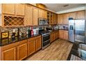 Well-equipped kitchen featuring stainless steel appliances, granite countertops, and wooden cabinets at 212 Lugano Way, Debary, FL 32713