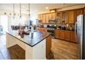 Open kitchen with a large island, granite countertops, and stainless steel appliances, perfect for entertaining at 212 Lugano Way, Debary, FL 32713