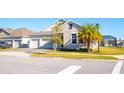 Charming single-Gathering home boasts stone accents, a two-car garage, and a well-manicured lawn at 2942 Wordsmith Rd, Kissimmee, FL 34746