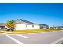 Exterior view of a modern home with solar panels and a screened-in pool area at 2942 Wordsmith Rd, Kissimmee, FL 34746
