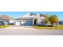 Charming two-story home with a two car garage, stone accents, and a well maintained lawn at 2942 Wordsmith Rd, Kissimmee, FL 34746