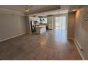 Open-concept living room and kitchen area with tile flooring and natural light at 3665 Brighton Park Cir, Orlando, FL 32812