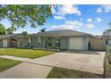 Inviting single-story home with a well-manicured lawn and an attached one-car garage at 3840 Cedarwaxwing Ave, Orlando, FL 32822