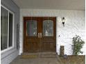 Inviting front entrance featuring double wooden doors and decorative stone accents at 4174 Fallwood Cir, Orlando, FL 32812
