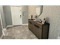 Inviting entryway with modern decor and a decorative console table with plenty of storage at 4687 Fairy Tale Cir, Kissimmee, FL 34746